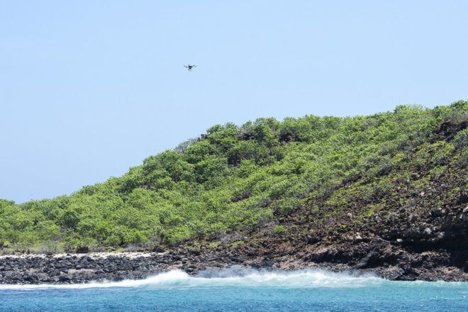A drone flying over a coast on the Galapagos Islands.