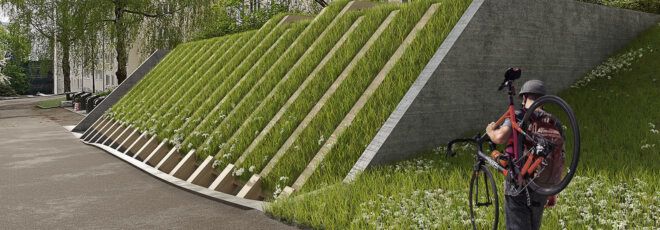 A person holding a bike and walking toward a bike parking area covered by a green roof.