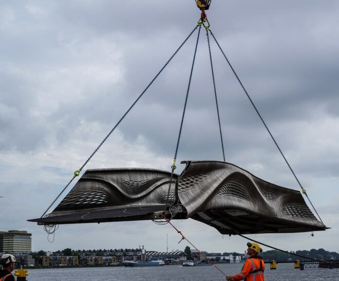3D-printed bridge piece being airlifted into place