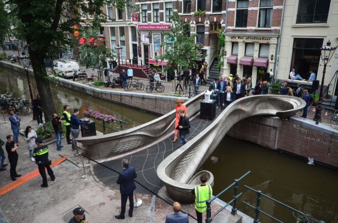 parade of people on 3d-printed smart bridge in Amsterdam