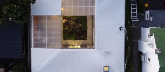 A bird's-eye view of a square white home centered around a courtyard.