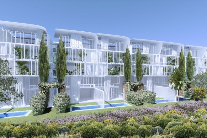A side angle of white box-like structures surrounded by plants, with pools in front.