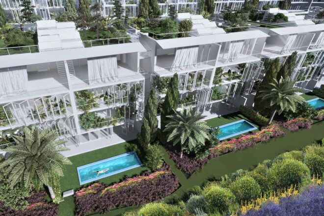An overhead angle of white box-like structures surrounded by plants, with pools in front.