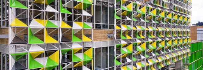A close-up of the building's green and yellow facade.