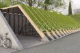 A bike parking area covered by a green roof.