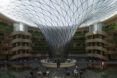 The inside of the hotel, showing a circular lobby with a glass structure emerging from the center and going up to form the hotel ceiling.