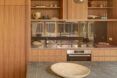 A kitchen with wood cabinets and slate countertops.
