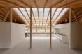 wood beams connected to wood ceiling with massive skylight