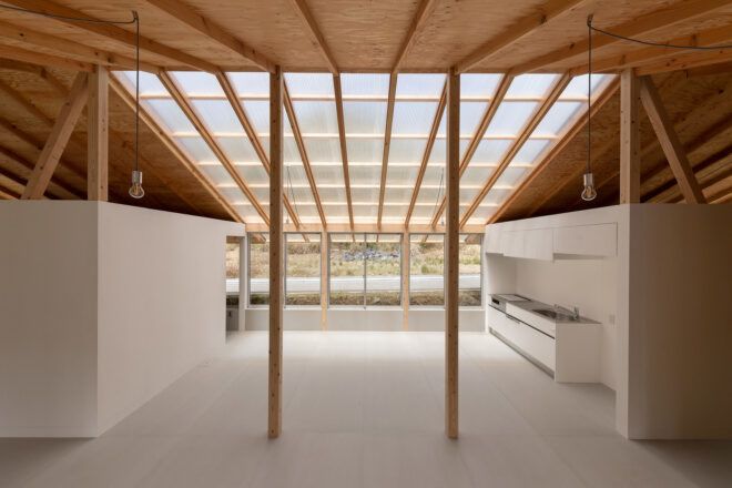 wood beams connected to wood ceiling with massive skylight