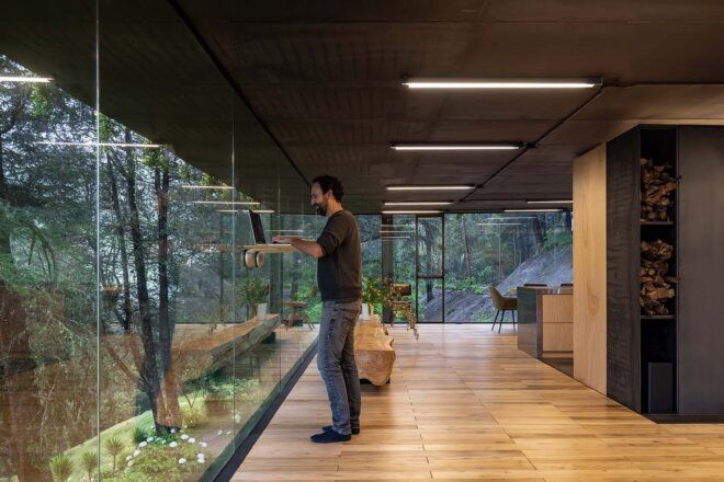 A person looking out through the floor-to-ceiling glass walls.