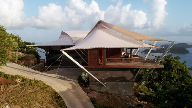 large home with white tensile roofs