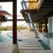 concrete path to patio surrounded by a pool