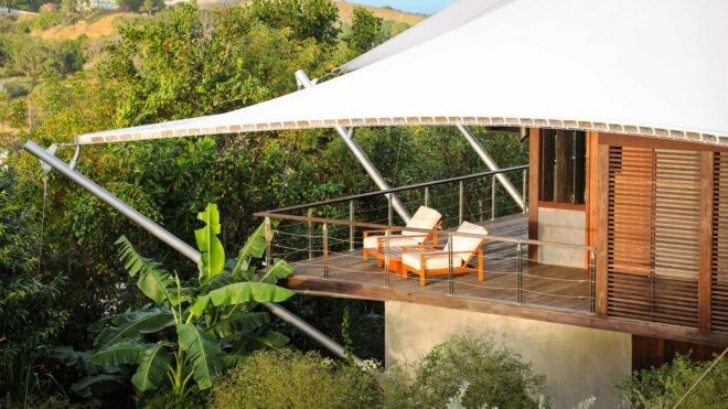 two white and wood chairs on a patio