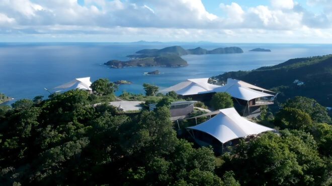 series of buildings with tensile roofs facing the ocean