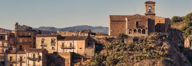 An Italian village along a mountainous crest.