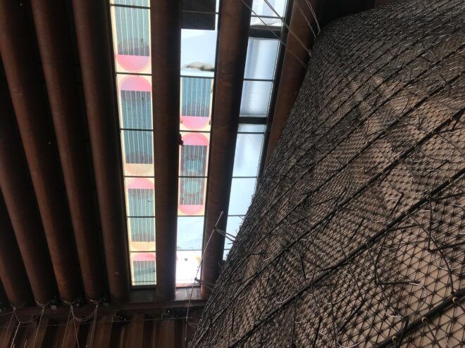 vertical farm under construction beneath colorful solar roof