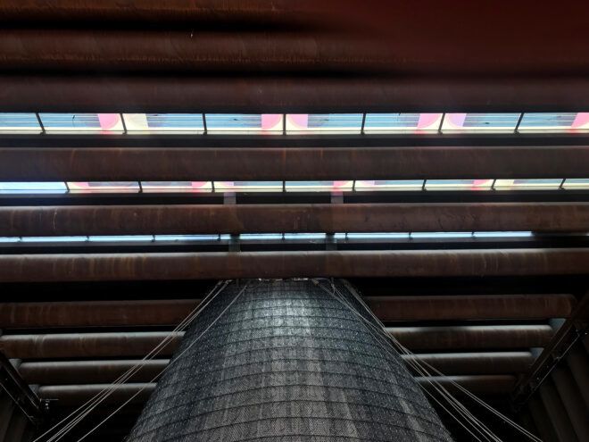 colorful solar panels shining light on vertical farm below