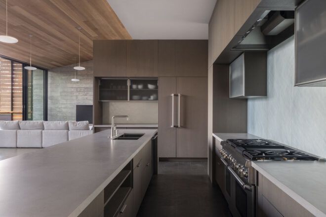A kitchen with beige cabinets and off-white counters.