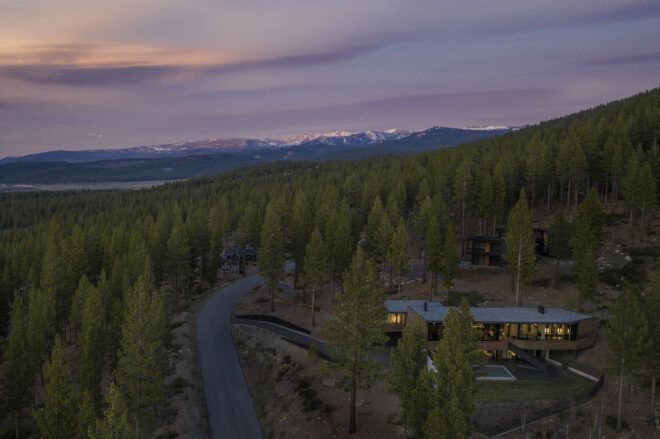 An overhead view of the home, surrounded by forest.