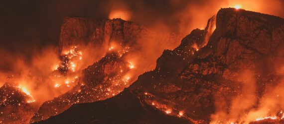 Wildfires across a mountain range.