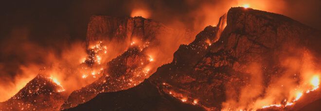 Wildfires across a mountain range.