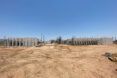 A construction site in the middle of a desert.