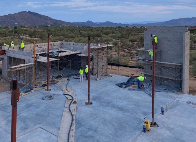 People working on the foundation of a construction site.