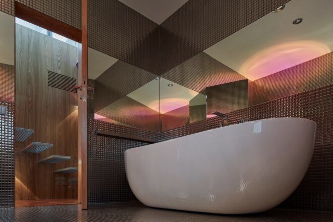 A bathroom with a large white bathtub.
