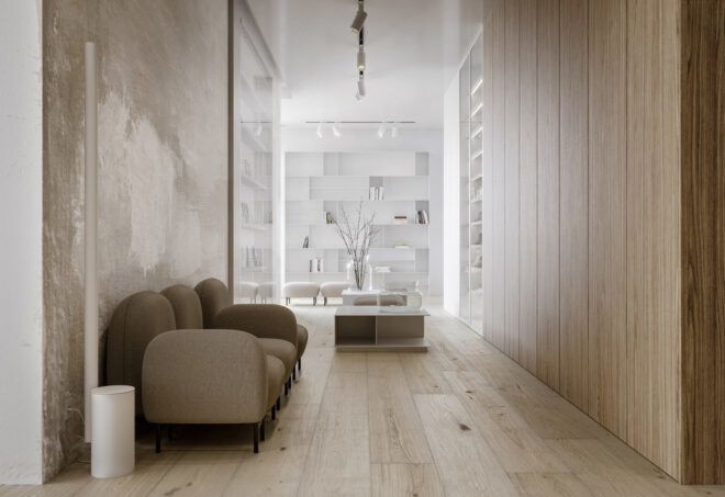 A hallway with wood floors and a beige sofa.