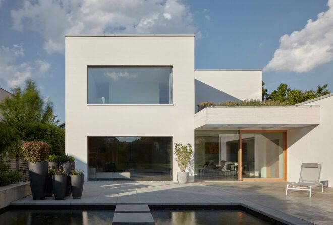 A closer view of the pool, which features a step stone path toward the home.