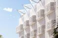 Day view of the Jali ventilation screens and projecting wind catchers that make up the façade.