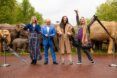 Four people in front of elephant sculptures