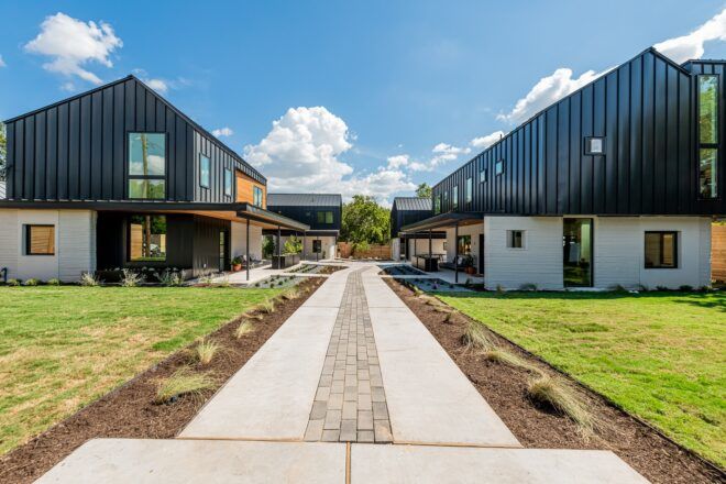 A walkway leading up to a community of homes.