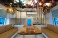 Fixed central table flanked by two seating benches resembling a ships interior