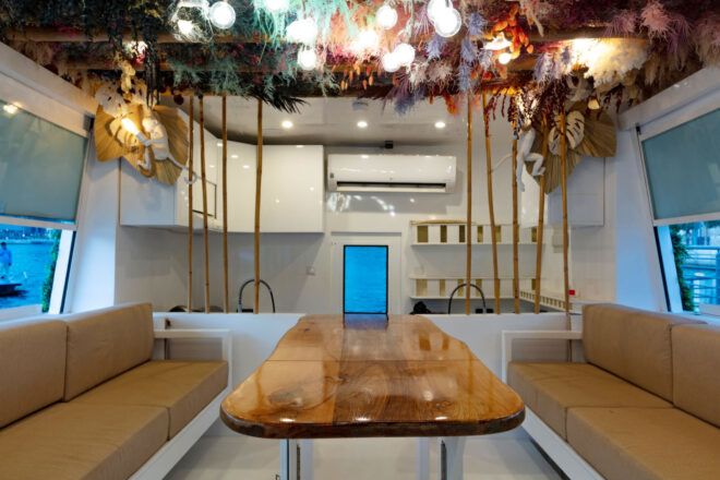 Fixed central table flanked by two seating benches resembling a ships interior