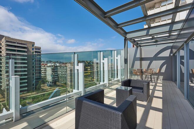 A city view from a glass lookout area at the top of the building.