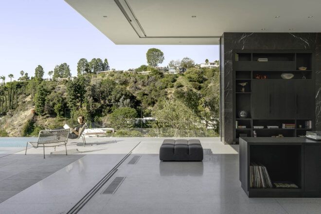 Living room corner that is fully open to a terrace and pool.