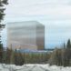 A snowy landscape with a cube-like structure in the distance.