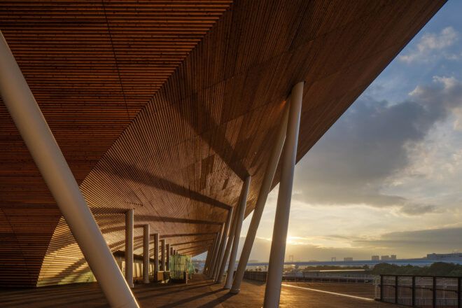 A wood overhang near an entrance that looks out over the city landscape.