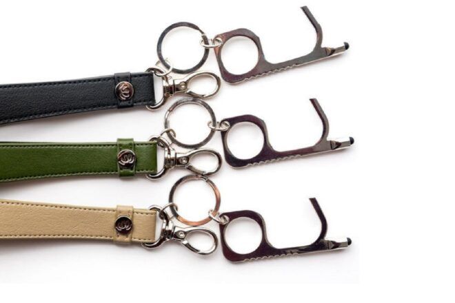 Three leather keychains in black, green and tan.