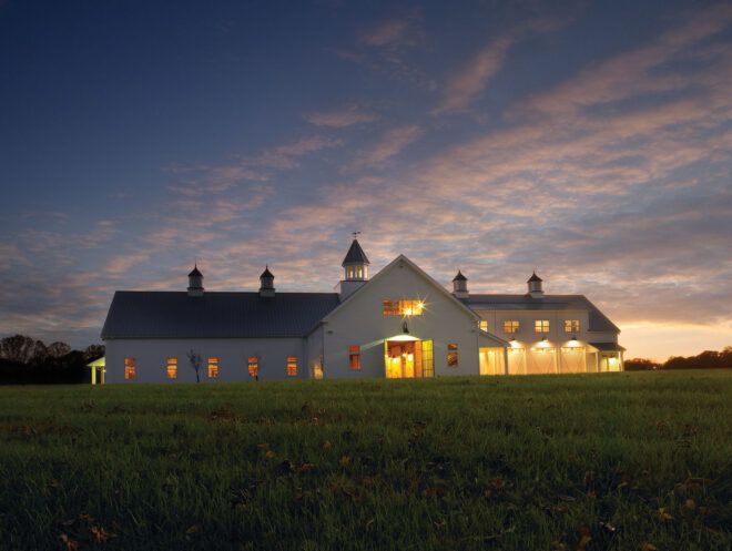 A landscape shot of the white building at dusk.