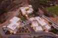 A bird's-eye view of a large campus in a desert area.