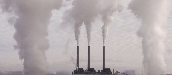 Smokestacks emitting clouds of pollutants.