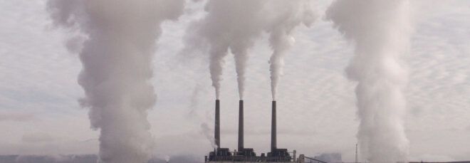 Smokestacks emitting clouds of pollutants.