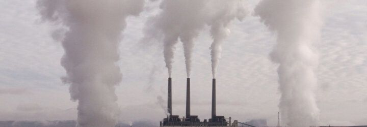 Smokestacks emitting clouds of pollutants.