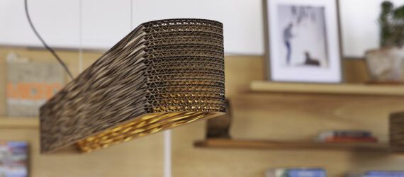A wicker lighting fixture hanging from the ceiling in a room.