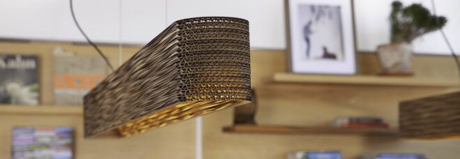 A wicker lighting fixture hanging from the ceiling in a room.