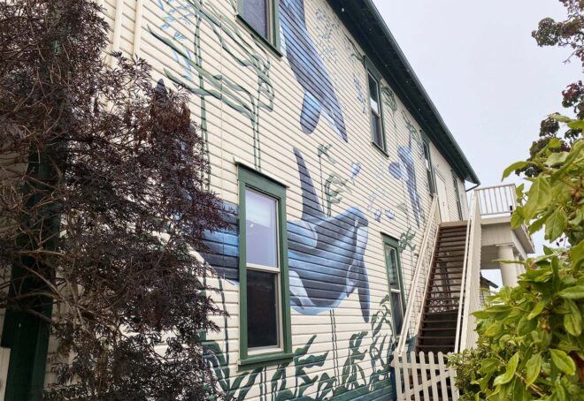 Whales painted on the outside of a building.