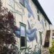 Whales painted on the outside of a building.