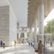 People walking through the lobby of an office building with white walls, floors and columns. Windows on the right overlook greenery.